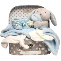 Baby gift set with plush toy, booties, and blankets in a star-patterned suitcase.
