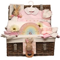 Baby girl strawberry themed gift hamper with pink smocked sleepsuit, Flopsy Bunny comforter and wooden teether in wicker basket.