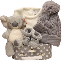 Grey Baby Gift Hamper With Knitted Hat, Booties, Cream Outfit, Plush Bear, And Star-Print Keepsake Box