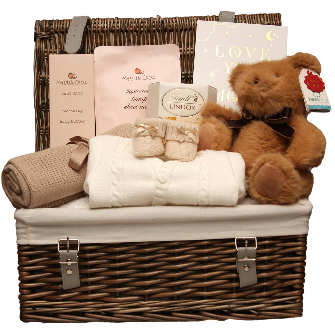Baby gift basket with teddy bear, blanket, and other items in a wicker basket.