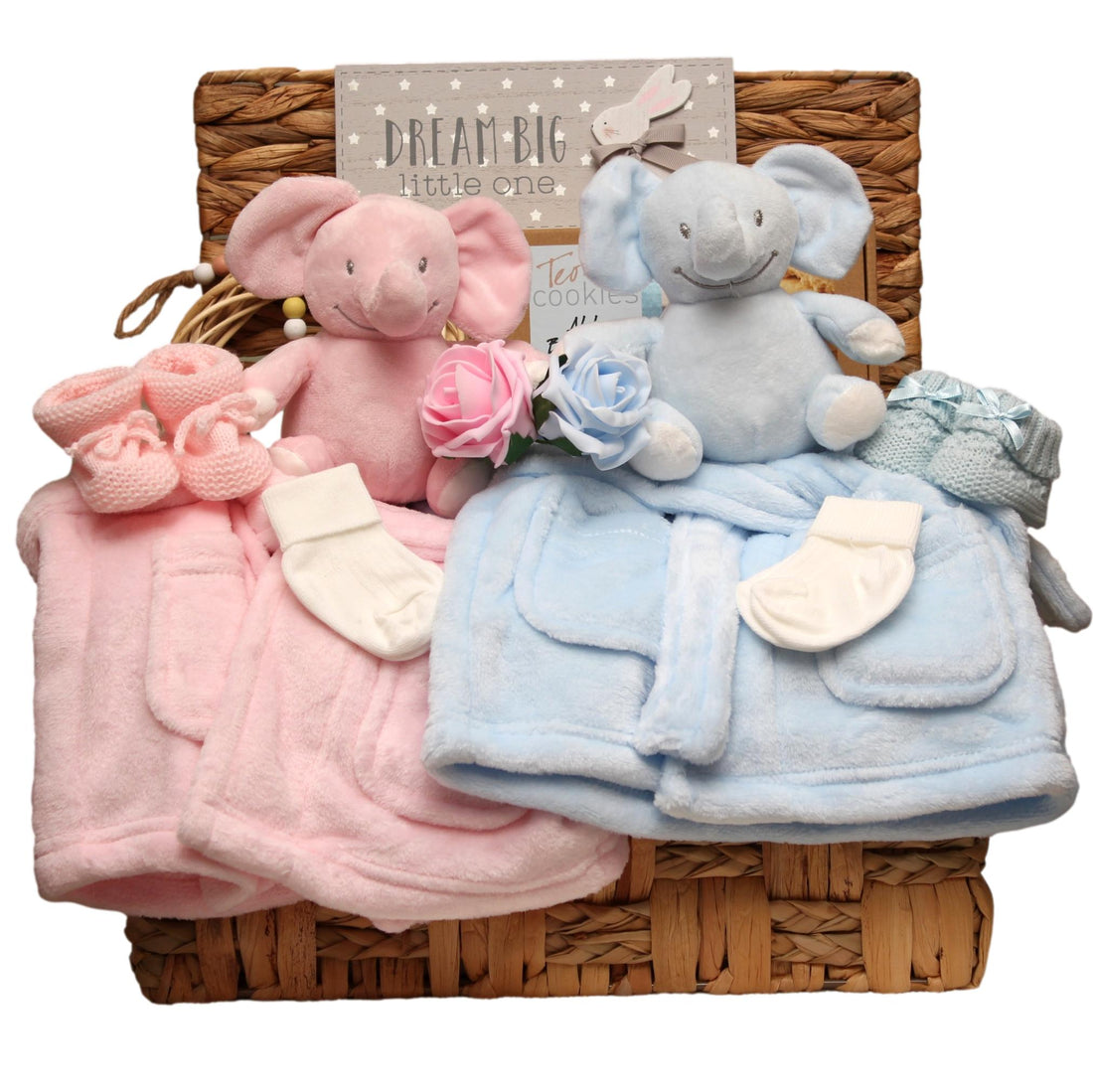 Baby twins gift set with plush elephant toys in blue and pink, matching dressing gowns and a 'Dream Big Little One' sign arranged in a basket. 
