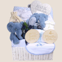 Luxury baby boy hamper with blue elephant soft toys, newborn clothing, baby brush set, milestone cards and keepsake gifts in white basket
