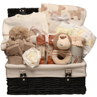 Unisex baby hamper with neutral baby essentials, soft blanket, baby clothing, toy and parent treats in a wicker basket