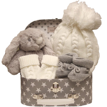 Baby Gift Set With Plush Bunny, Knitted Hat, And Booties In A Star-Patterned Box.
