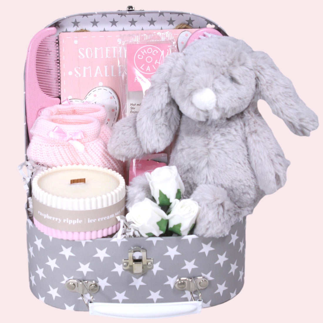 Luxury baby girl newborn hamper with bunny toy, cosy booties and keepsake suitcase.