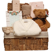 Seagrass baby basket with a teddy bear, knitted cardigan and gifts for new mum